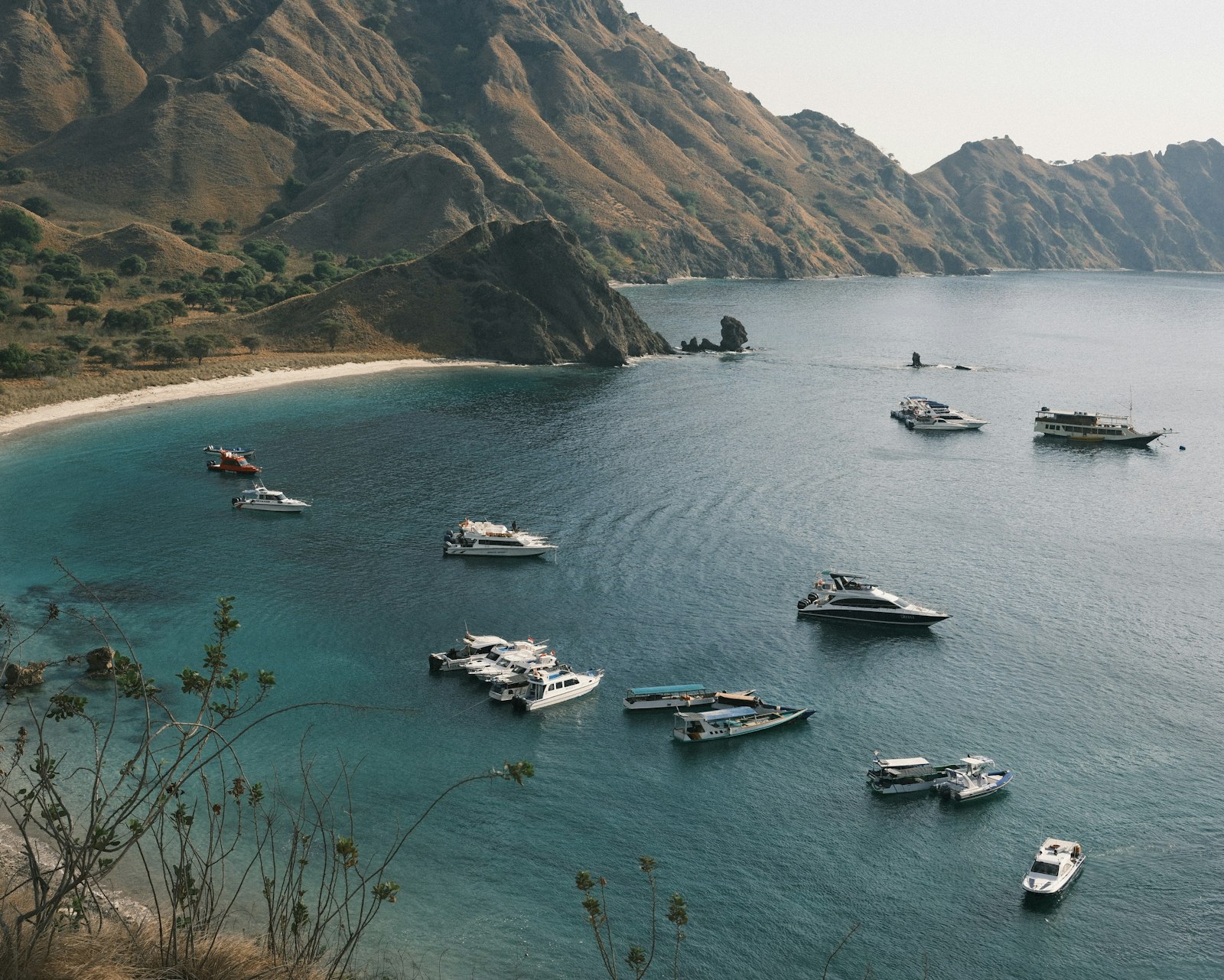 A group of boats floating on top of a body of water